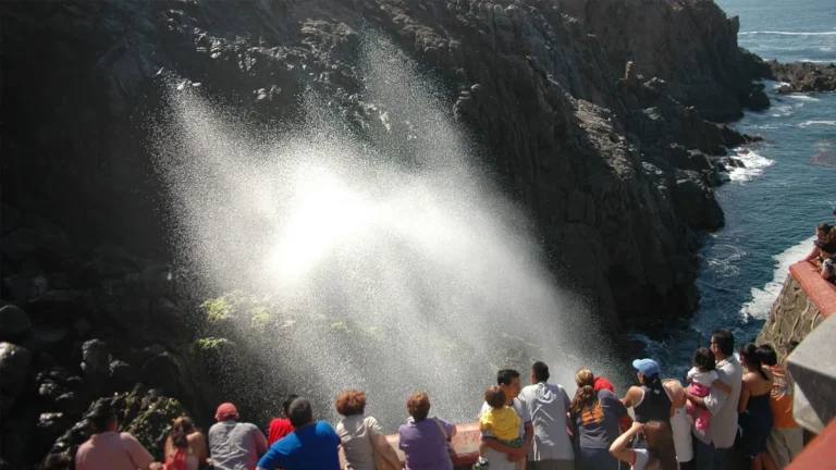 a hillside in mexican displaying water crashing and splashing up against the hill